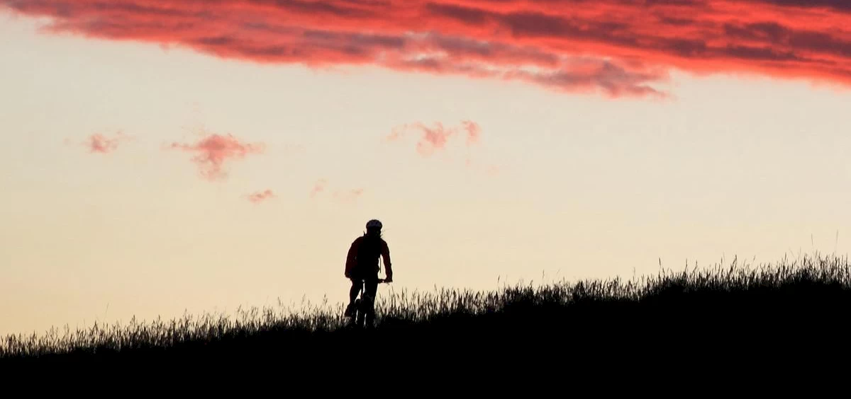 image of biker at sunset riding a mountain bike | Telluride