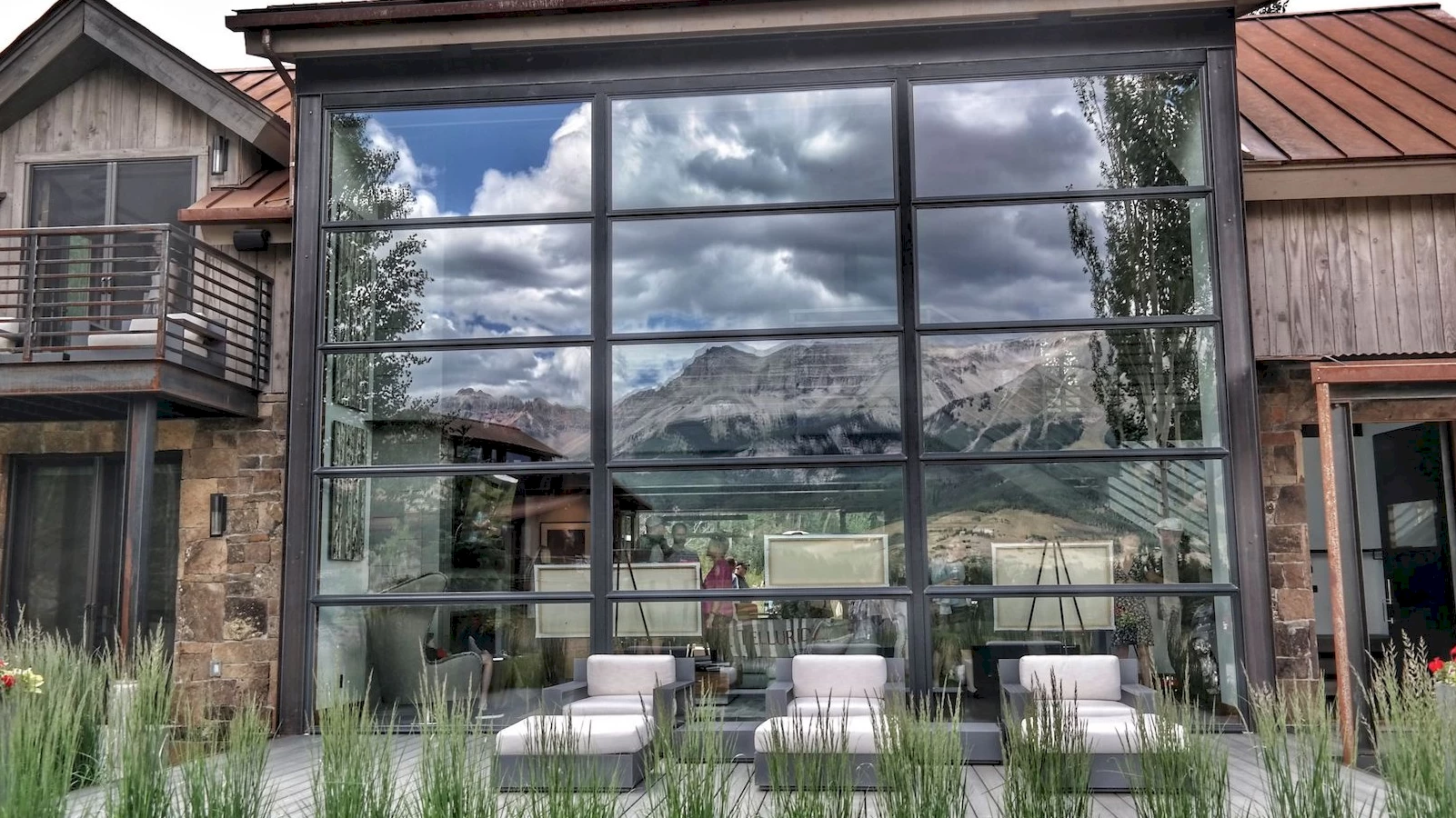 image of a building with lots of windows reflecting a mountain scene for the Telluride Art + Architecture Festival