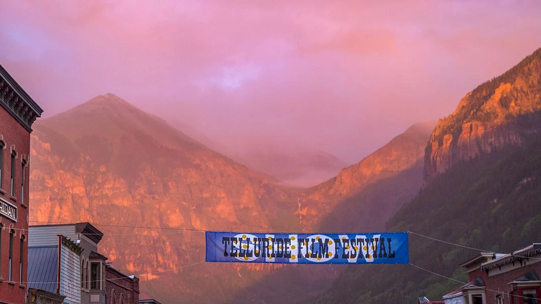 image of Telluride at dusk with a banner for the Telluride Film Festival