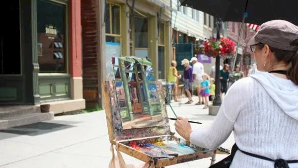 image of an artist paining on a murel for Telluride Plein Air Festival